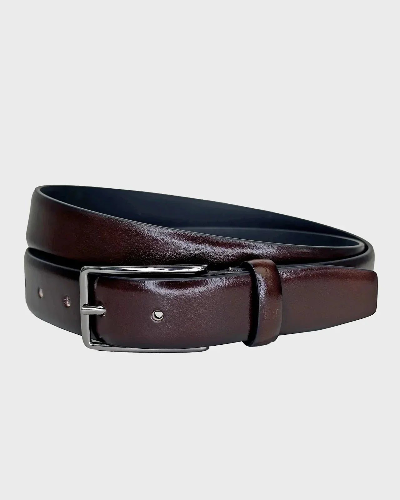 Brown leather belt with a silver buckle on a light gray background