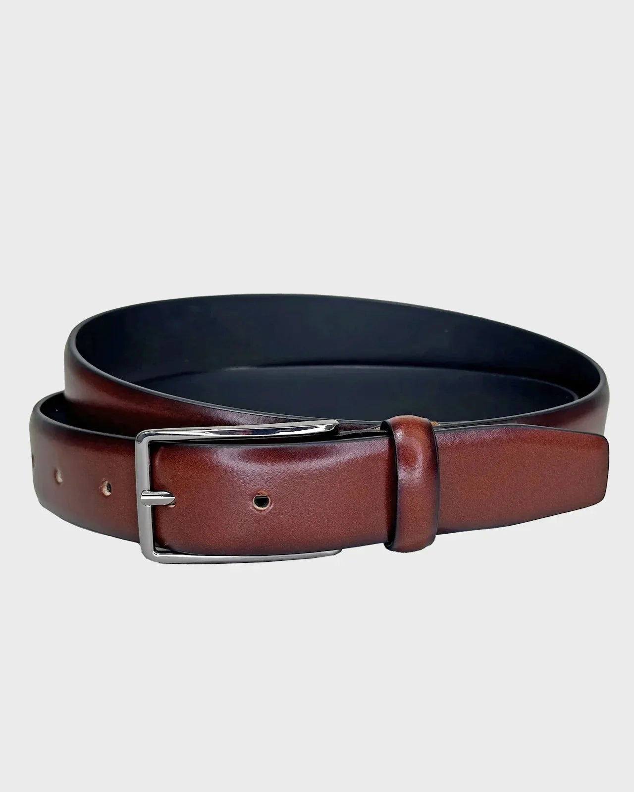 Tan leather belt with silver buckle on a light gray background