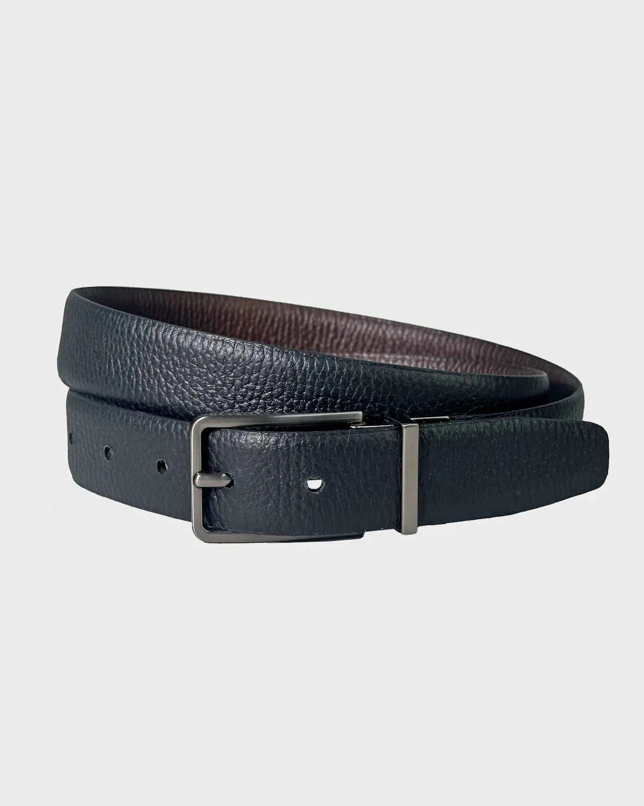 Black leather belt with a silver buckle on a light gray background